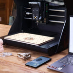 Through-cutting operation on HiMill CNC using sacrificial MDF spoilboard.
